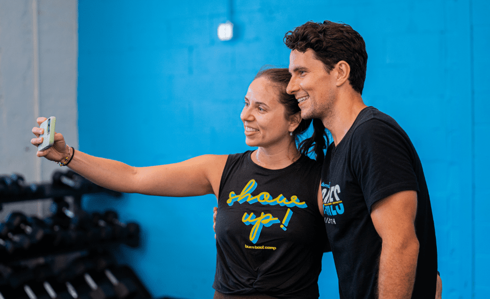 a couple posing for a photo inside of a burn boot camp