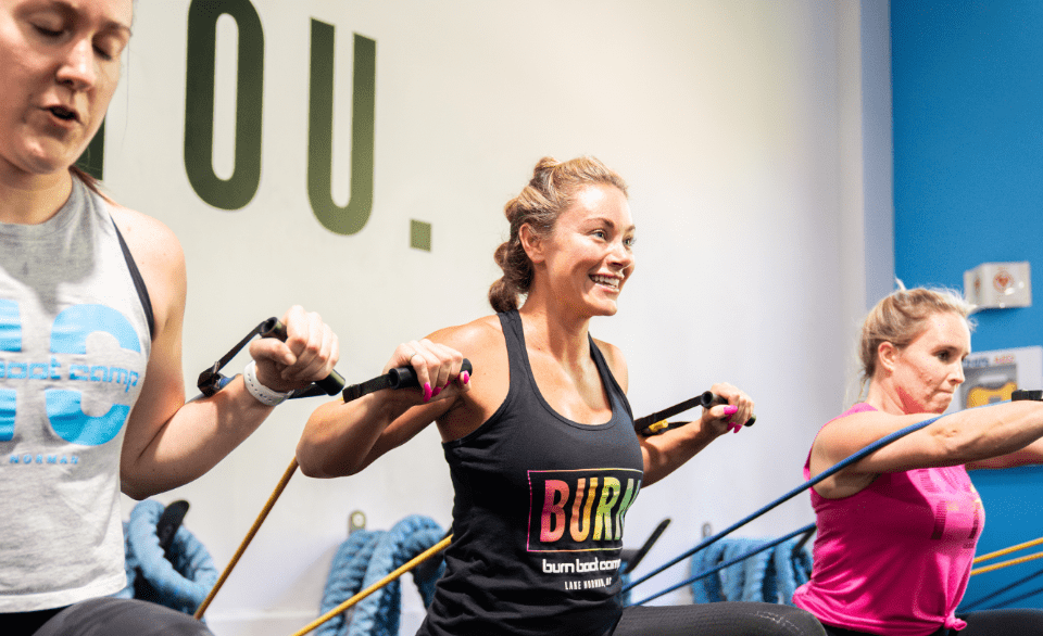 burn boot camp members doing an arm workout